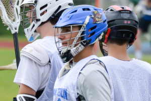 Drei Spieler in weißer Jacken und Helmen mit einem unscharfen Hintergrund.